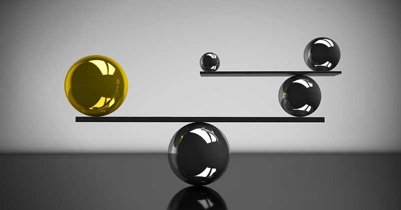 Conceptual image of marbles on a balance
