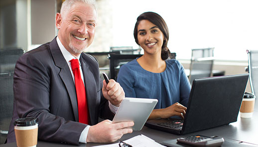 Man and woman smiling while having a meeting