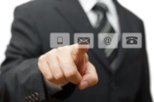 Businessman pressing virtual contact buttons