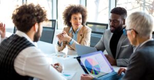 Business professionals talking around a table