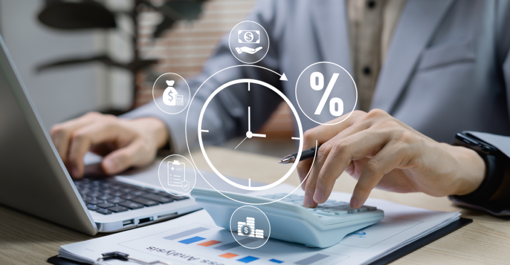 Business professional working at a laptop with a holographic clock and financial icons floating above a calculator, representing time management, budgeting, interest rates, and financial planning.