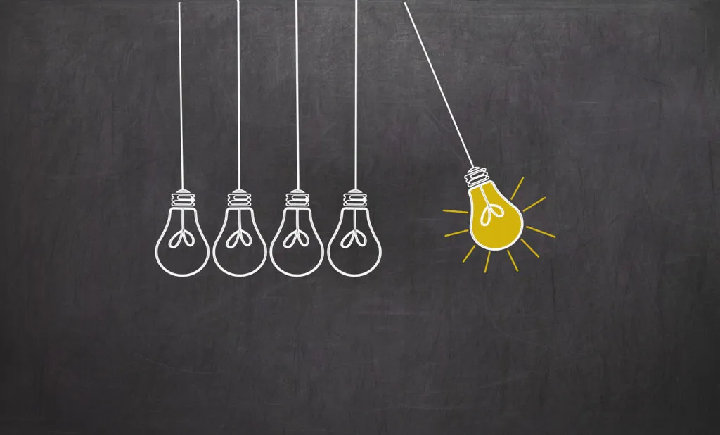 Creativity concept with light bulbs on chalkboard background