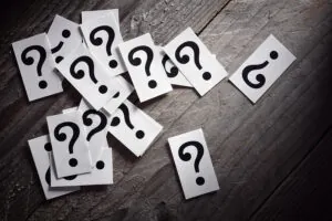 Question mark heap on table concept for confusion